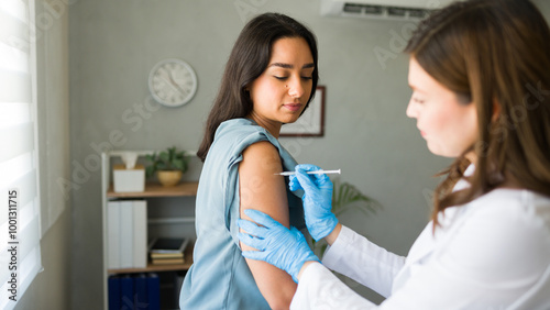 Hispanic woman is getting a vaccination from a healthcare worker, promoting overall wellness