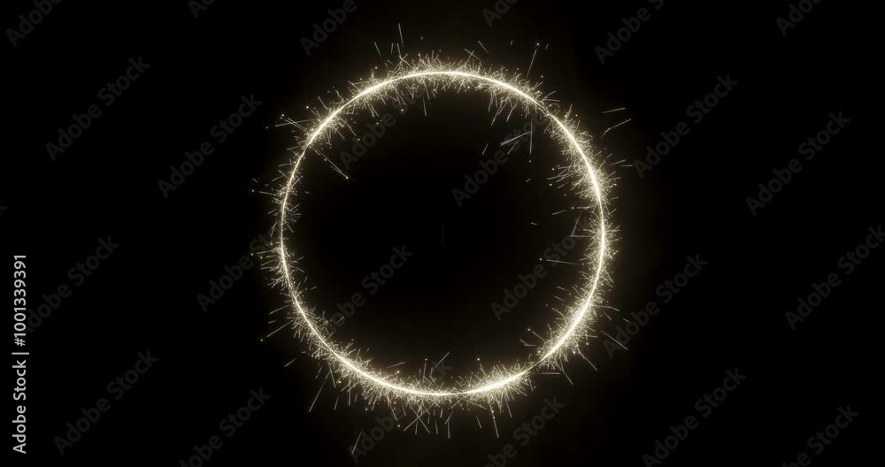 A sparkling firework sparkler forming a circle shape on a dark black background with alpha