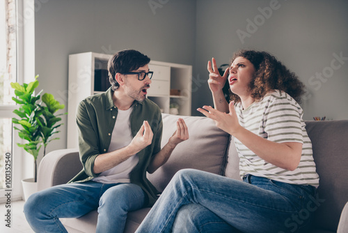 Photo of two young people sitting couch communicate fight modern interior apartment indoors photo