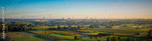 Aerial panorama view on Waasland rural area mixed with wind turbines and harbor of Antwerp in the far distance during sunrise