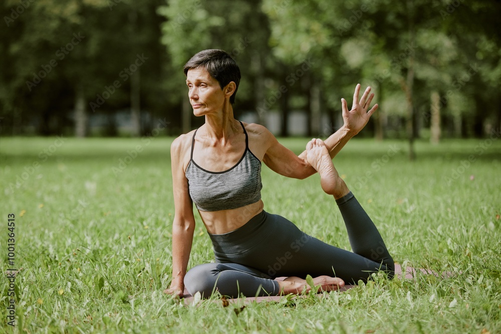 Senior toned woman sitting in yoga pose on mat, she enjoying process and harmony Senior toned woman sitting in yoga pose on mat, she enjoying process and harmony