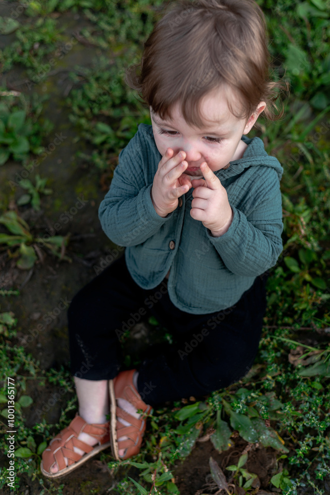 A boy on the shore in the green grass has a picnic A boy on the shore in the green grass has a picnic
