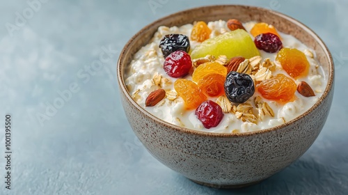 A delicious bowl of yogurt topped with granola, dried fruits, and nuts, perfect for a healthy breakfast or snack.