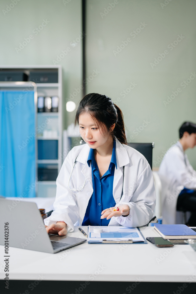 Confident young female doctor in white medical uniform sit at desk working on computer. Confident young female doctor in white medical uniform sit at desk working on computer.