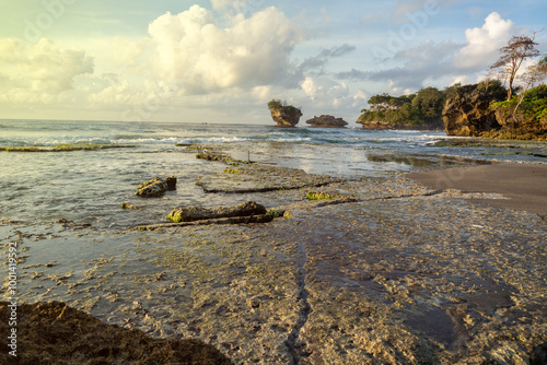 beach rocks with sunset at pangandaran beach in Indonesia, Beautiful natural summer vacation travel concept. photo