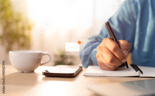 A Businessman writing on notebook , While mobile phone have notifies new inbox email notification icon, newsletter. Technology digital online network. Technology communication concept.