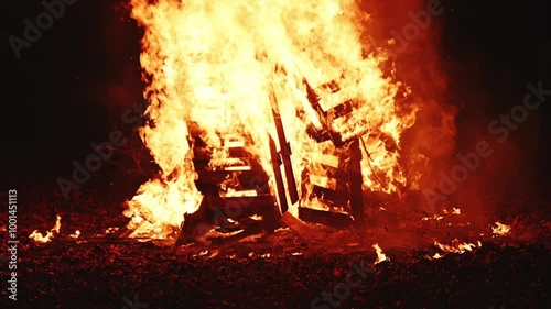 Bonfire pyre burning at night, bright orange flames of fire, 4K