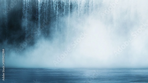 A close up view of a waterfall with mist over still water.