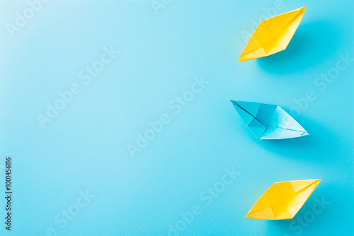 Free Download An AI generative image of top view blue and yellow origami paper boat on blue background - GFXLoad