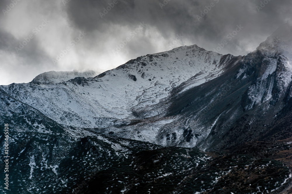 Snowy mountains in plateau area in cloudy weather Snowy mountains in plateau area in cloudy weather