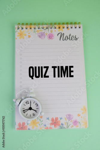 the words Its Quiz Time with laptop, white alarm clock and a cup of coffee. the concept of answering quizzes or quiz games