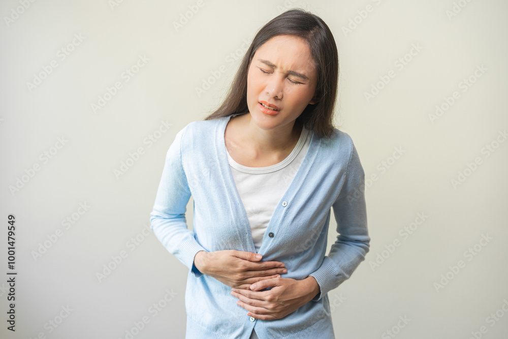Obraz premium Flatulence ulcer, asian young woman, girl hands in belly, stomach pain from food poisoning, abdominal pain and digestive problem, gastritis or diarrhea. Abdomen inflammation, menstrual period people.