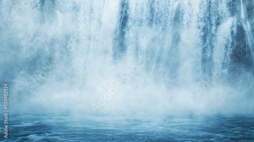Misty waterfall cascading into calm blue water.