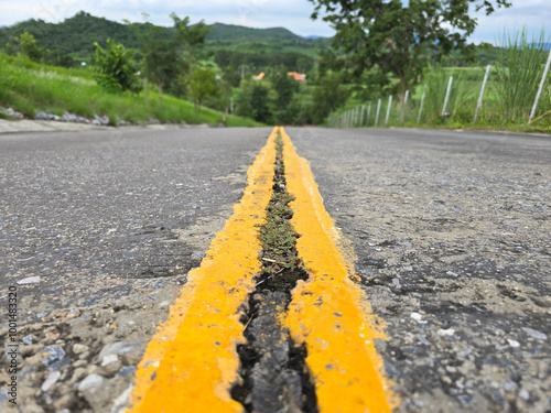 Road Crack on double yellow line of the road