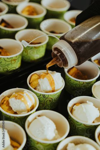 food service cattering homemade hanmade ice cream poured with caramel souce dressing photo