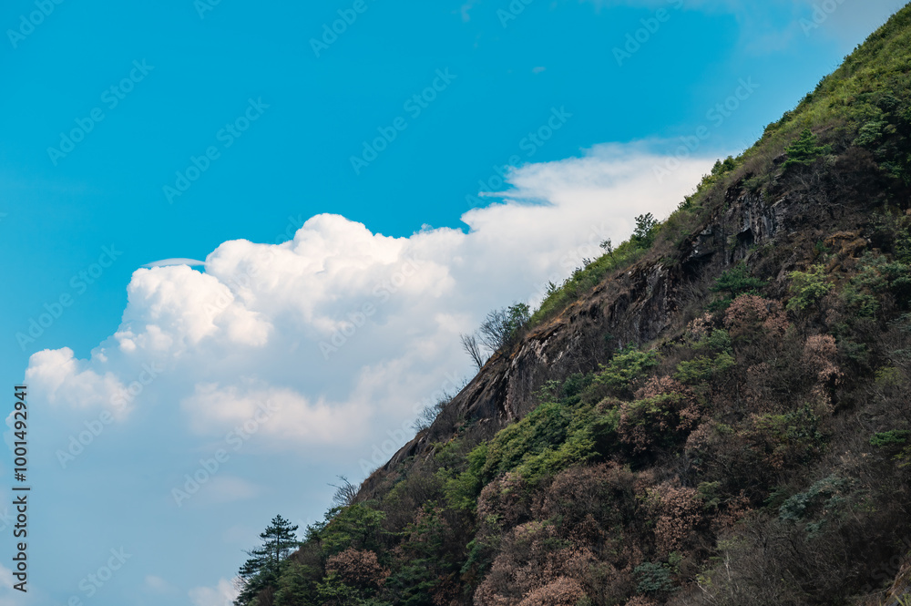 Mountain slopes and blue sky with white clouds Mountain slopes and blue sky with white clouds