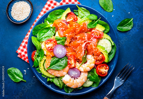 Fotografie Salmon salad for ketogenic diet with shrimp, avocado, spinach, cucumber, tomato, cashew nuts, sesame