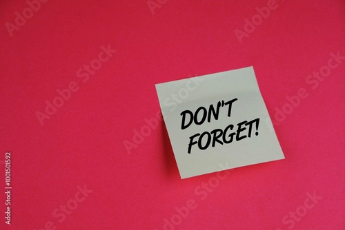 copy space of pink background with note pad written DONT FORGET 