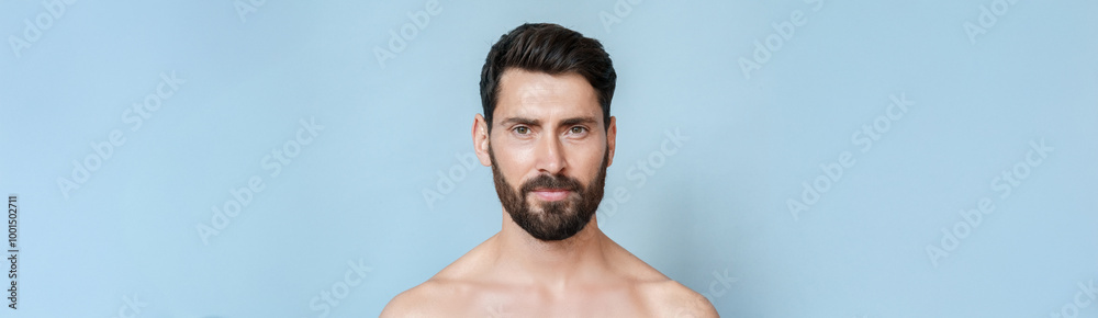 Closeup headshot portrait of mature smiling handsome bare shoulders man having beard, perfect skin looking at camera isolated over blue background. Masculine, healthcare, bodycare. Banner, copy space Closeup headshot portrait of mature smiling handsome bare shoulders man having beard, perfect skin looking at camera isolated over blue background. Masculine, healthcare, bodycare. Banner, copy space