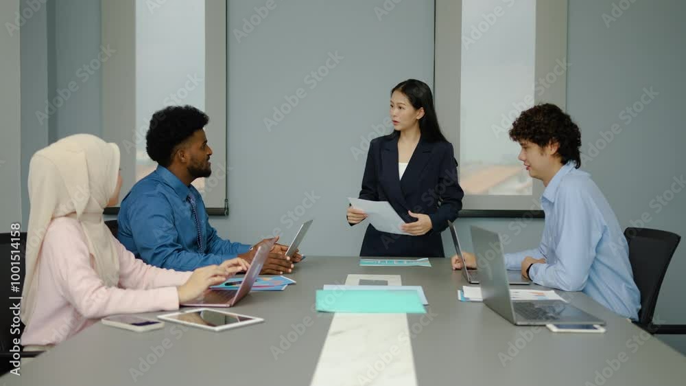 Group of multicultural business people in a discussion during a business meeting in a conference room. Happy business people, men and women, collaborating and working towards their shared goals Group of multicultural business people in a discussion during a business meeting in a conference room. Happy business people, men and women, collaborating and working towards their shared goals
