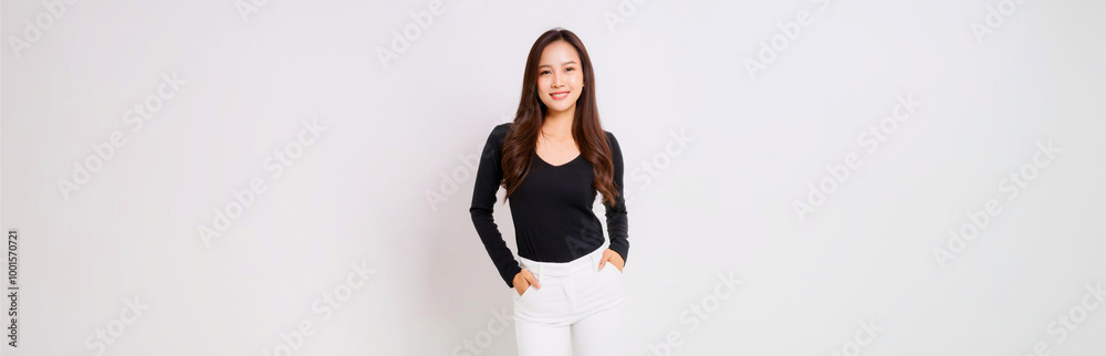 A portrait of a Southeast Asian woman wearing a black long-sleeve T-shirt and white skinny pants. A portrait of a Southeast Asian woman wearing a black long-sleeve T-shirt and white skinny pants.