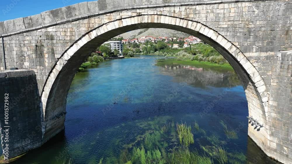 Drone flyover under historic Arslanagic Bridge in Trebinje