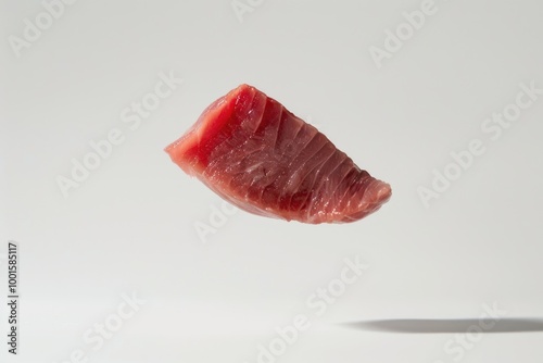 A piece of raw meat is flying through the air