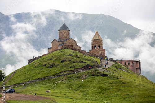 breathtaking view of a mountain range with a ancient Gergeti Trinity Church, under Mount Kazbek near the village of Stepantsminda in Georgia