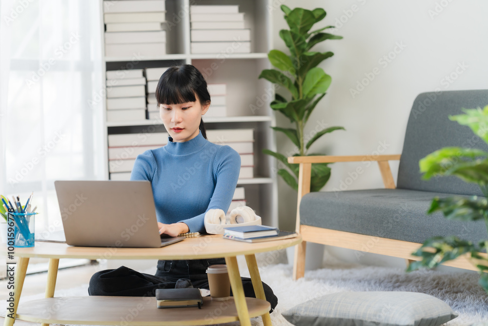 Focused and Productive: Young Asian Woman Working from Home Focused and Productive: Young Asian Woman Working from Home