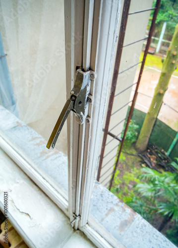 Vertical lock on an old window from the USSR era photo