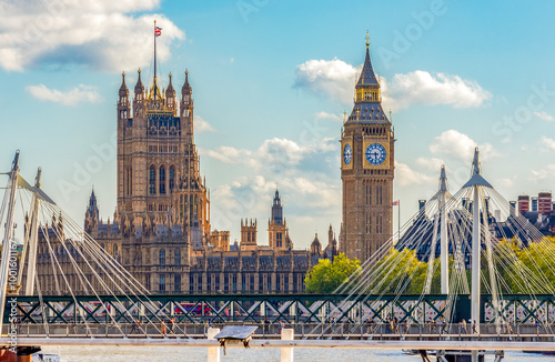 Big Ben and Houses of Parliament seen from Waterloo bridge through Golden Jubilee bridge, London, UK photo