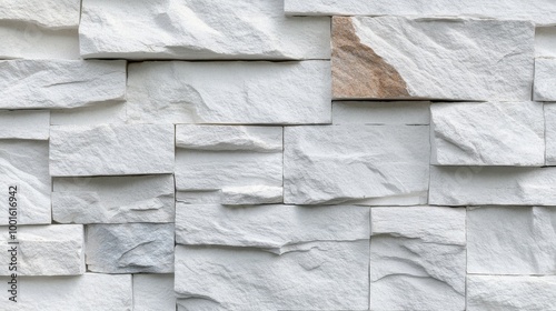 Textured white stone wall tiles arranged in an organized pattern for modern i...