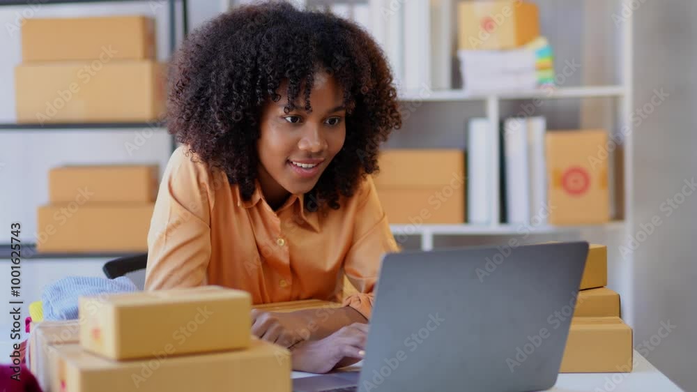Entrepreneur processes orders on a laptop while working in a warehouse, managing logistics and inventory efficiently Entrepreneur processes orders on a laptop while working in a warehouse, managing logistics and inventory efficiently