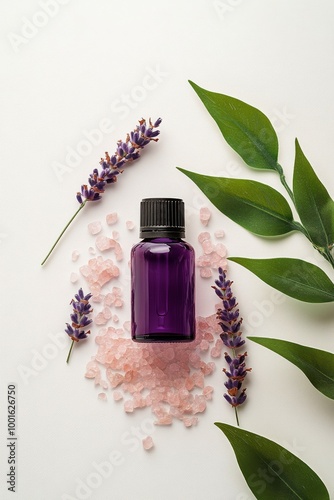 Lavender essential oil bottle surrounded by flowers and leaves on a white sur...