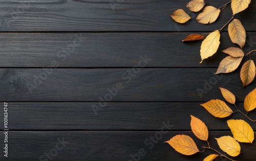 Autumn leaves scattered on a dark wooden surface in natural light during fall