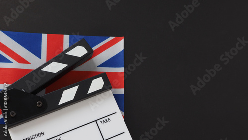 clapper board and uk flag on black background