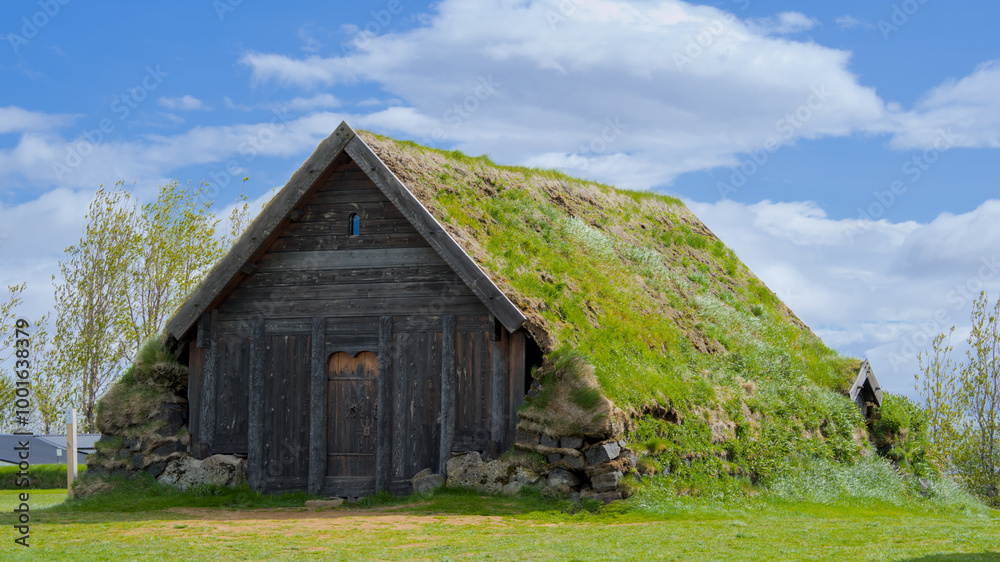 Traditional icelandic wooden house with thatched roof and green grass Traditional icelandic wooden house with thatched roof and green grass