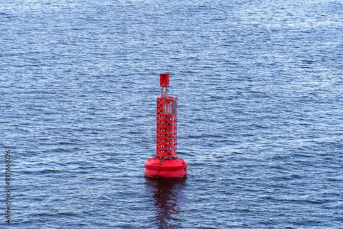 Illuminated red buoy signaling the fairway leading to the Port of Swinoujscie, Poland photo