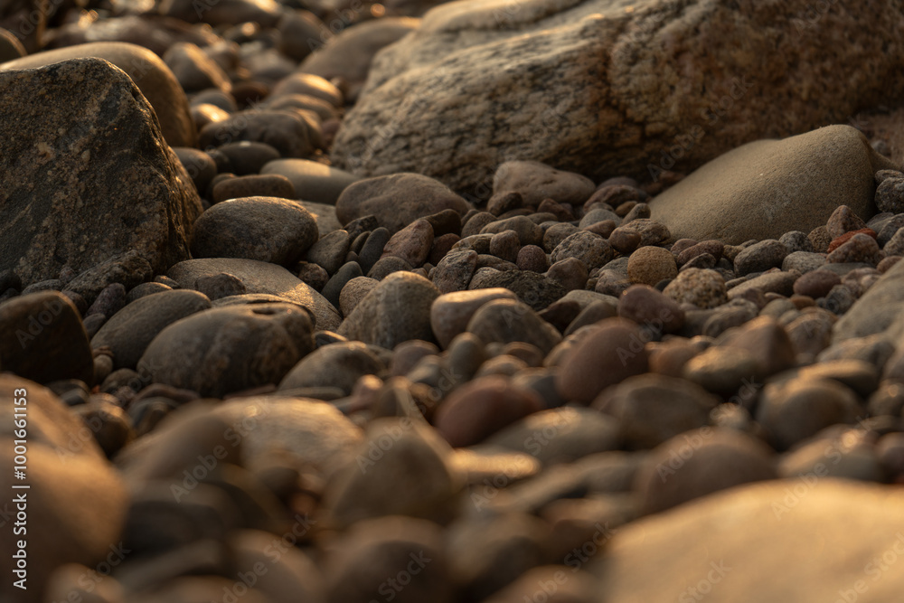 lake stones close up in sunset golden light - wallpaper background lake stones close up in sunset golden light - wallpaper background