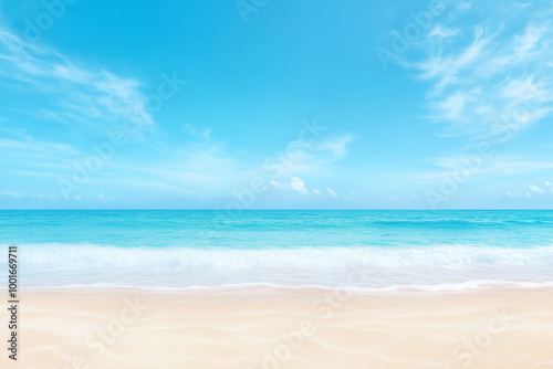 Calm beach with clear blue sky and gentle waves at midday on a sunny day