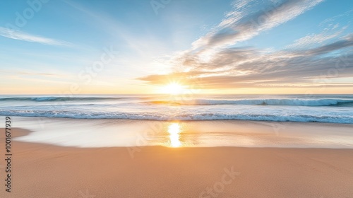 A breathtaking sunrise over a sandy beach with gentle waves crashing ashore. The sun's rays illuminate the sky with warm hues and reflect off the water's surface.