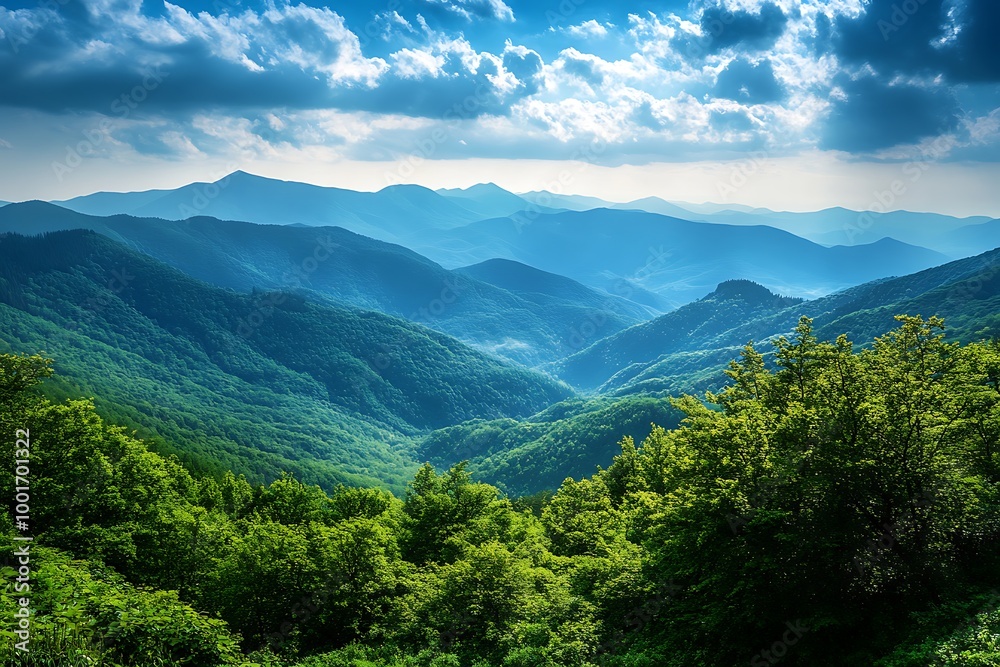 Obraz premium Aerial View of Mountain Range with Lush Greenery and Dramatic Clouds