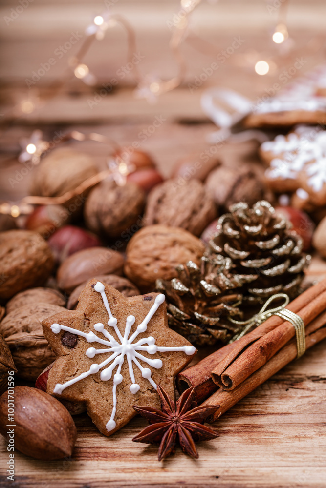 A snowflake-shaped gingerbread cookie with white icing on a wooden table, surrounded by assorted nuts, cinnamon sticks, star anise, a pinecone, and warm star-shaped fairy lights in the background. A snowflake-shaped gingerbread cookie with white icing on a wooden table, surrounded by assorted nuts, cinnamon sticks, star anise, a pinecone, and warm star-shaped fairy lights in the background.