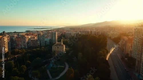 Aerial view of a park and city skyline at sunrise in Spain