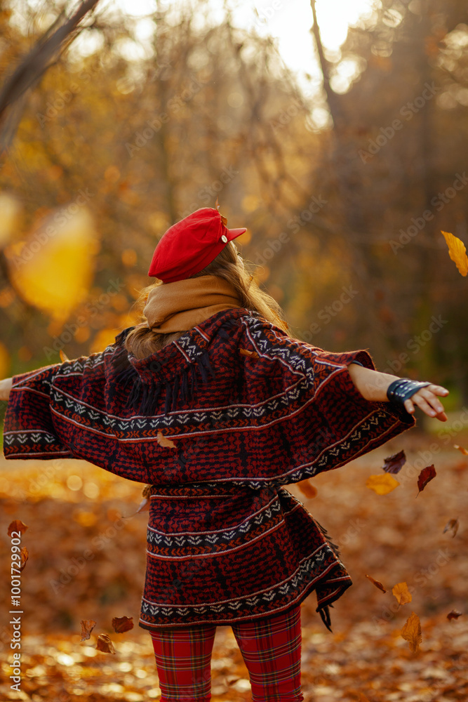 Seen from behind female in red hat with scarf rejoicing Seen from behind female in red hat with scarf rejoicing