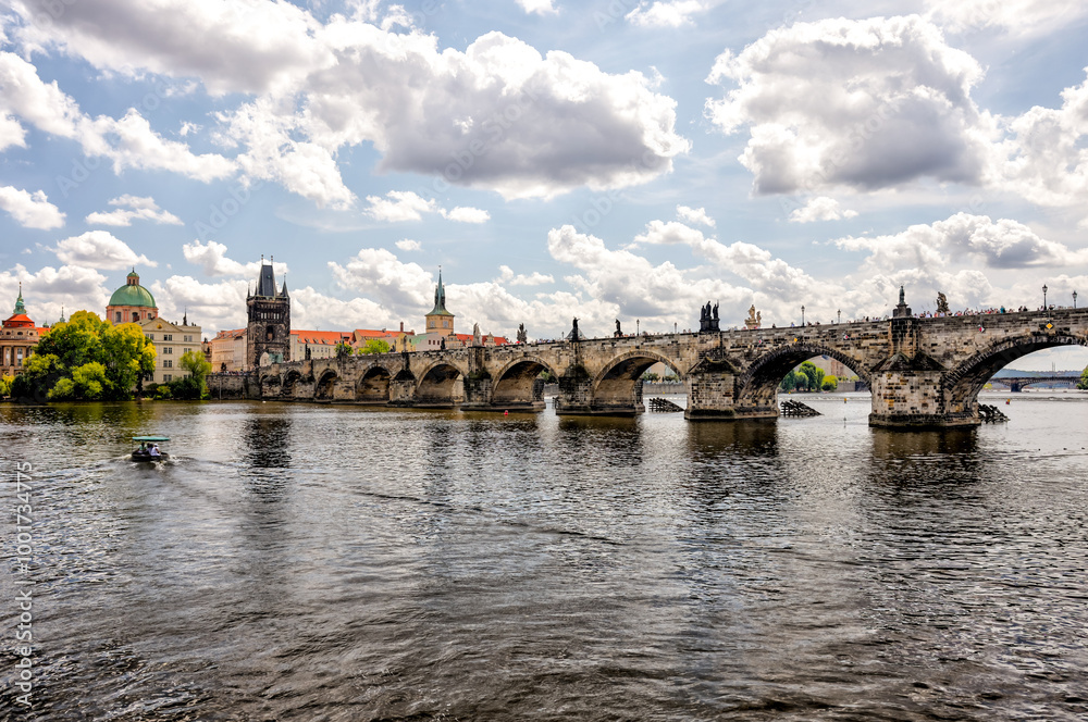 Fototapeta premium Prague, Czech Republic - July 19, 2024: Morning views along the Vltava River and Charles Bridge n Prague in the Czech Republic