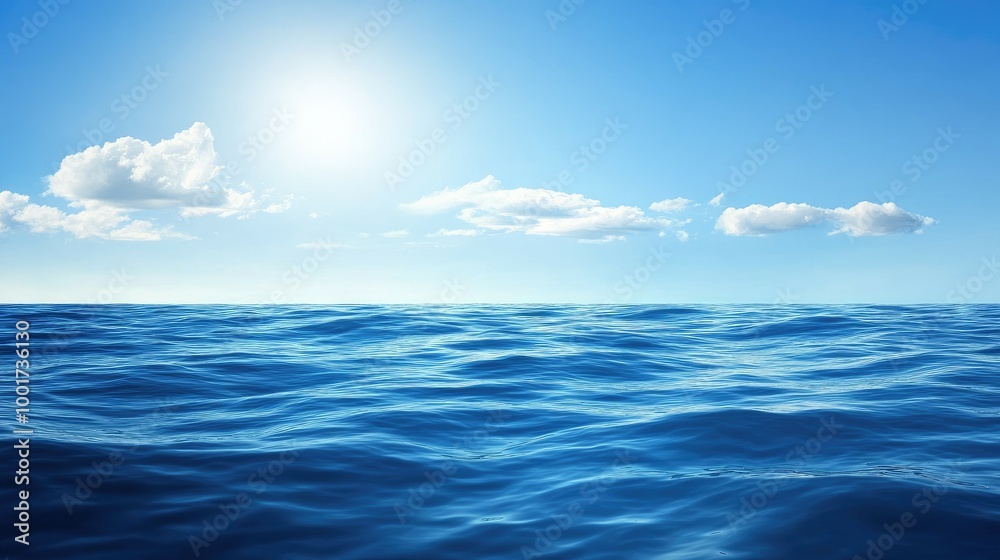 Obraz premium A vast expanse of blue ocean water under a bright, sunny sky with fluffy white clouds.