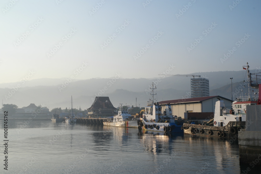 Fototapeta premium Exploring the tranquil morning at Dili Ferry Harbor in Timor-Leste with boats dotting the calm waters