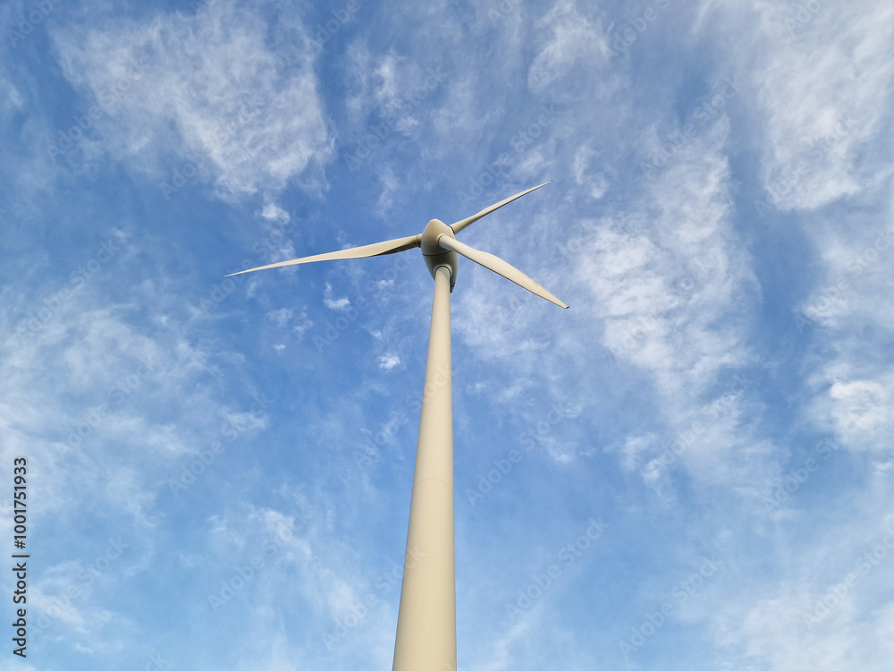 Wind Turbine in Rural Landscape Under Blue Sky Wind Turbine in Rural Landscape Under Blue Sky