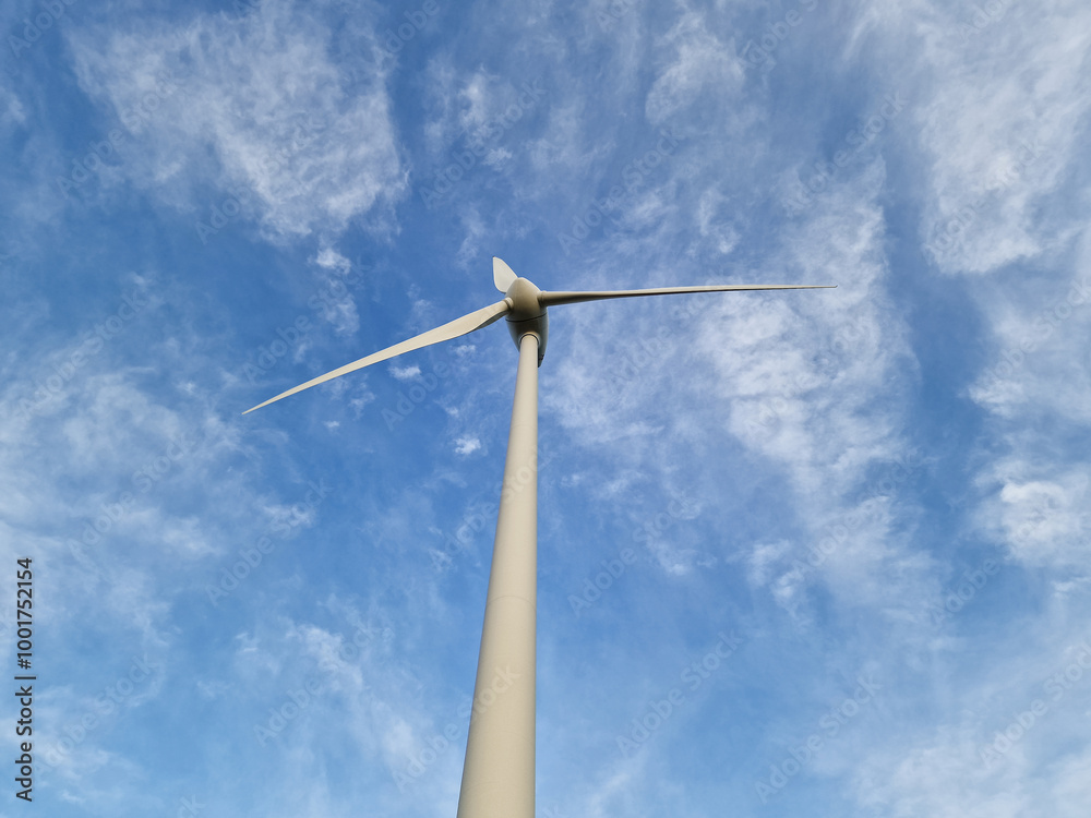 Wind Turbine in Rural Landscape Under Blue Sky Wind Turbine in Rural Landscape Under Blue Sky